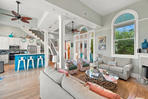 A spacious living area with a sofa, coffee table, and a view of the outdoors.