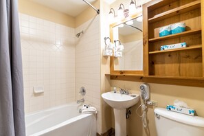 Combined shower/bathtub, towels, soap, toilet paper