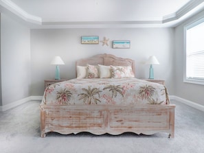 A bedroom with a bed, two nightstands, a starfish decoration, and a window. - Havens 925 Recently Renovated and Great Location! (North Myrtle Beach)