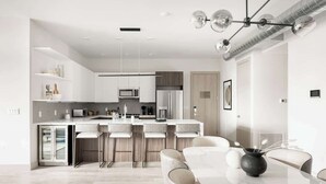 A modern kitchen with a central island, bar stools, and a dining table with chairs. - Modern Penthouse | Private Skyline Balcony (Denver)