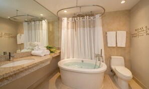 Bathtub, hair dryer, towels, shampoo