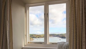 A room with a window seat overlooking a body of water and hills. - Magdala - 5 BR property Sleeps 10 w/stunning views (Salcombe)