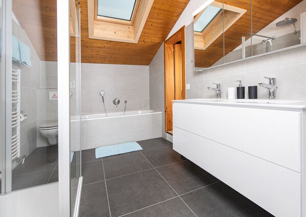 Bathtub, hair dryer, towels, soap