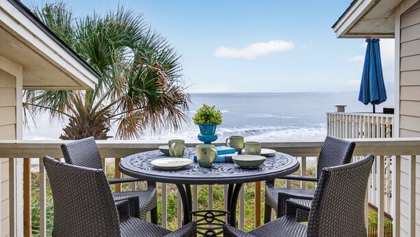 A round table with chairs on a balcony overlooking the ocean. - OCEANFRONT Views, Community Pool, Modern, Ideal Wild Dunes Location! (Isle Of Palms)