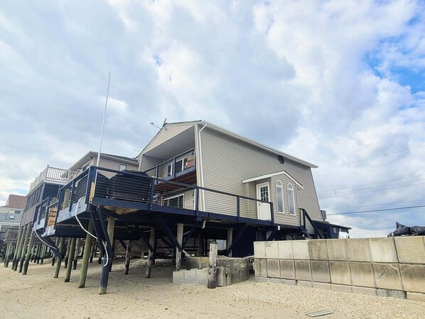 A two-story house with a balcony and a covered porch area.