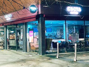 A Costa Coffee shop with a modern exterior and large glass windows. - Short Term Shared R&R In Chorlton (Manchester)