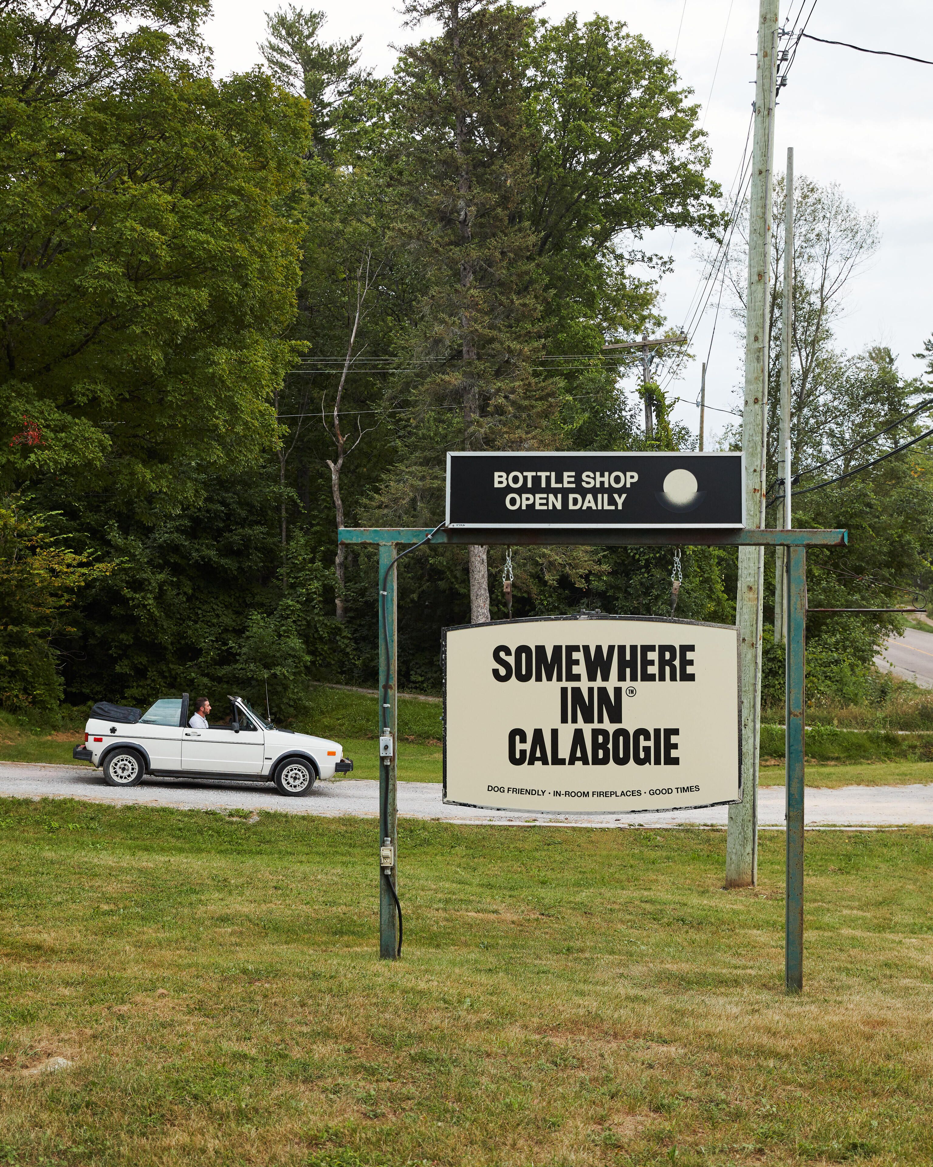 A sign for a bottle shop and a motel named 'Somewhere Inn Calabogie'.