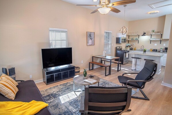 Relax in this spacious living area with a sofa, coffee table, and flat-screen TV.