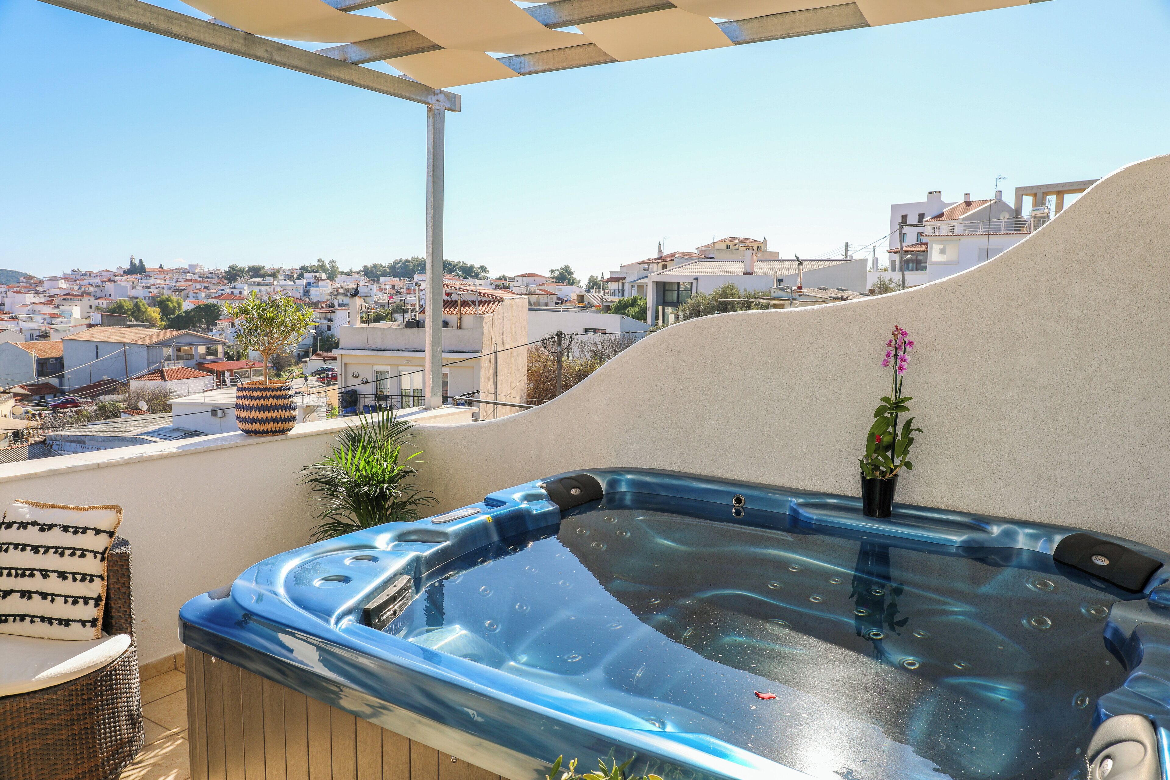 A hot tub on a rooftop with a view of a town.