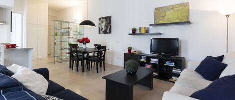 Deluxe Apartment, 1 Bedroom | Living area | 43-inch TV with digital channels