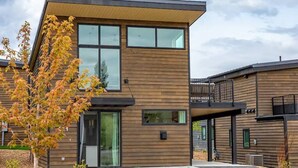 A modern two-story building with large windows and a wooden facade. - LUX Modern Retreat: Hot tub & Pool, Perfect Location! (Whitefish)