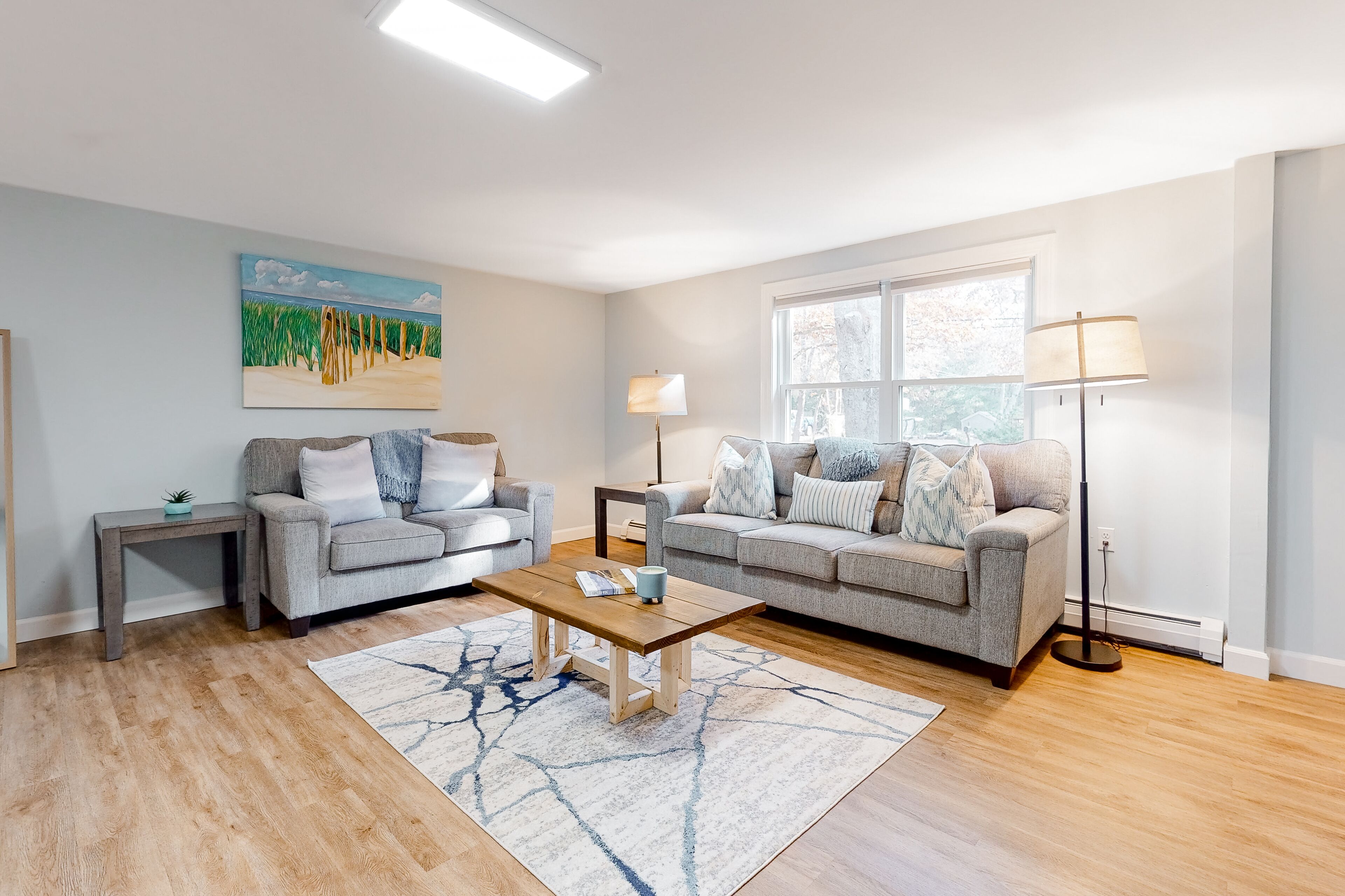 Half-Acre Haven home with central AC, grill, dining patio, and lush lawn