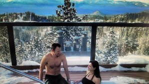 A couple in a hot tub with a snowy landscape view. - Experience Tahoe's Ski Scene at Holiday Inn Club Vacations Tahoe Ridge Resort (Stateline)