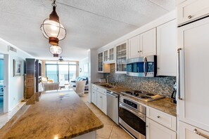 Fridge, microwave, oven, stovetop - Oceanfront condo with stunning view, large balcony, AC, WiFi & shared pool (Ocean City)