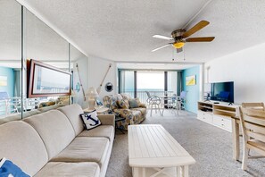 Relax in this inviting living space with a sofa, coffee table, and dining area.
