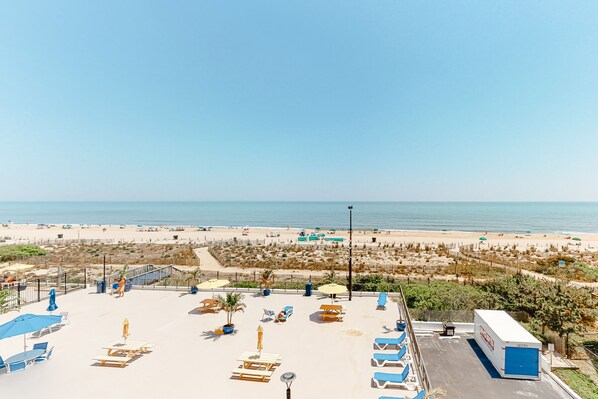 Relax on the rooftop terrace with sun loungers and umbrellas, taking in the panoramic view of the beach and ocean.