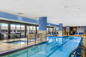 Relax by the rectangular pool surrounded by lounge chairs and a seating area.