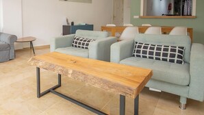 A modern living room with grey sofas, a wooden coffee table, and artwork on the walls. - Fuentes de la Duquesa B.3.6 (Manilva)