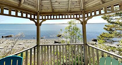 Charming home with stunning bay views, sunroom, gazebo, deck, & grill