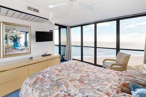 Relax in comfort with a large bed, flat-screen TV, and stunning beach views.
