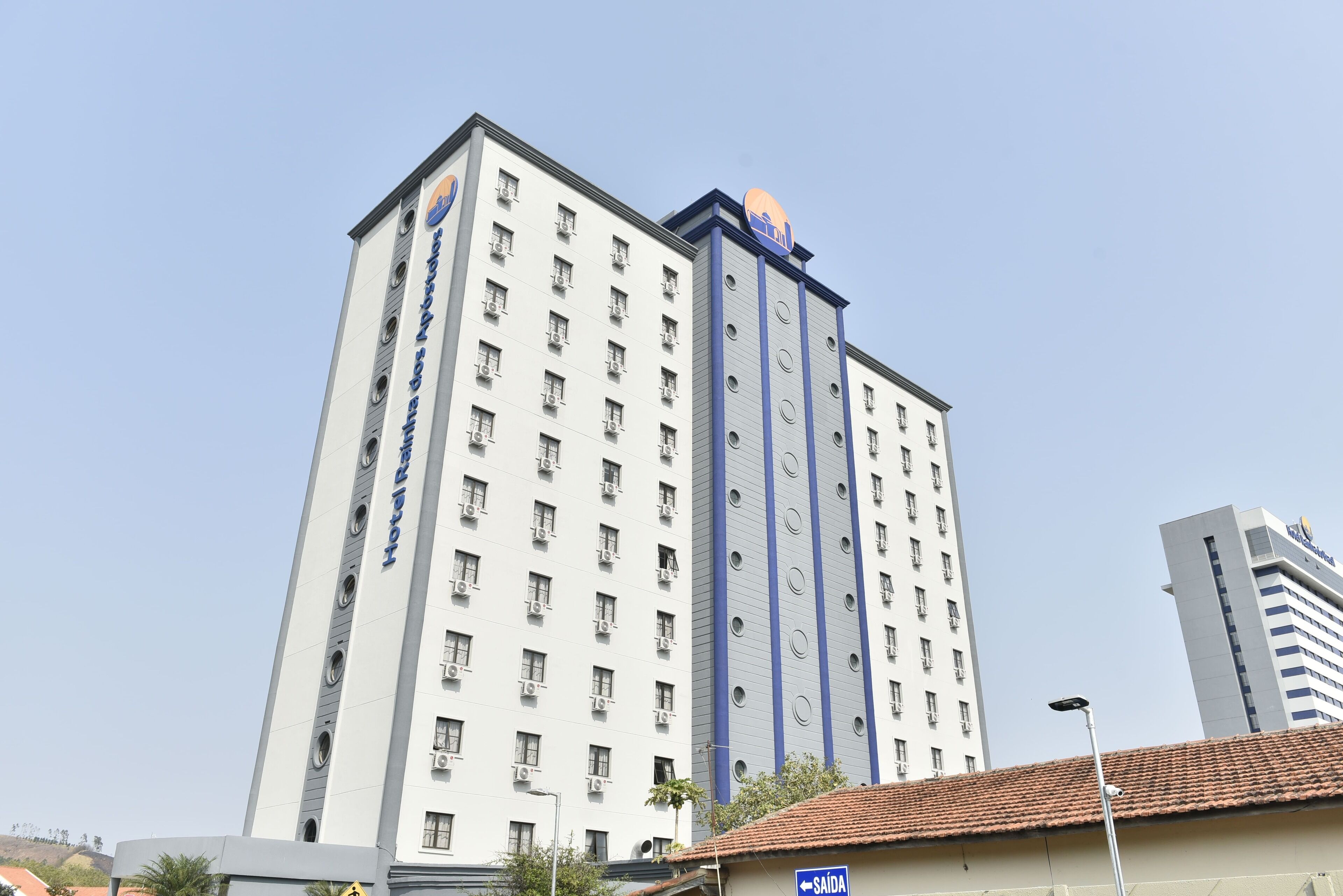 A multi-story hotel with a prominent sign on the top.