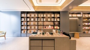 A modern bookstore with a central counter, shelves of books, and a minimalist design.