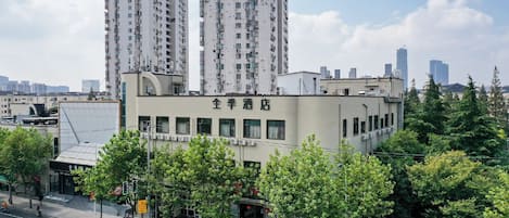 A building with multiple floors, a sign with Chinese characters, and a street with parked motorcycles.