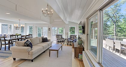 Spacious lakefront home on lush 5-acre lot with sunny deck & private dock
