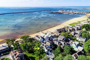 Stunning coastal homes line the shore, offering serene views of the ocean and surrounding greenery.