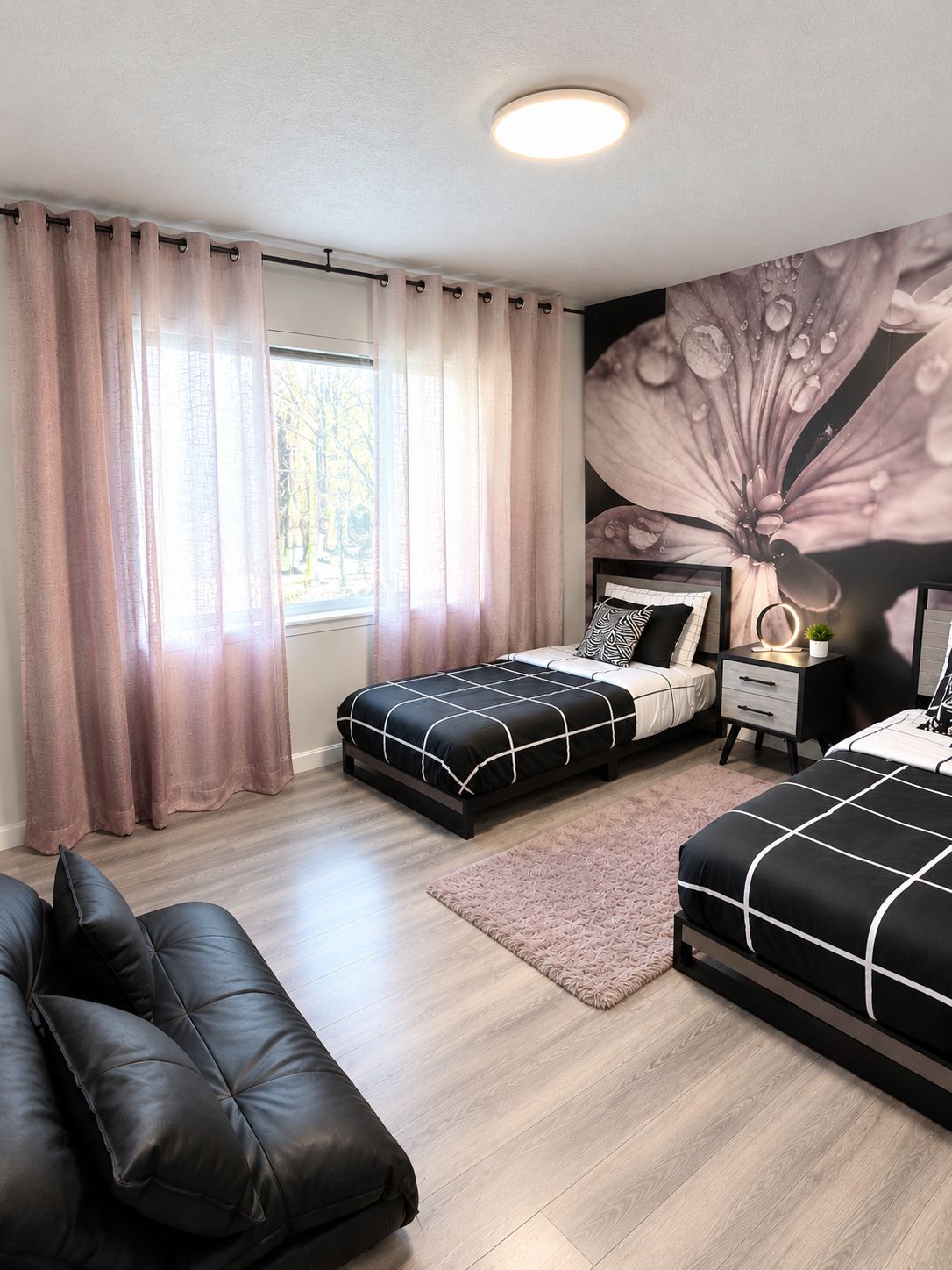 A bedroom with two beds, a nightstand, a dresser, a large window with curtains, and a wall mural.