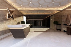 A modern lobby with a reception desk, a geometric ceiling design, and a marble floor.
