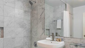 A modern bathroom with a bathtub, sink, and toilet.