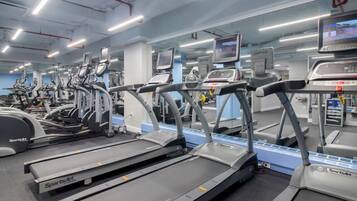 A gym with multiple treadmills and exercise equipment.