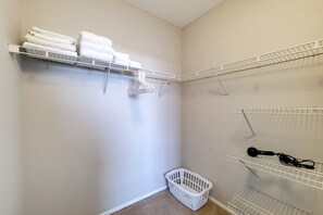 A laundry area with shelves holding folded towels and a laundry basket. - White Plains One Bedroom, Short Walk to Train (White Plains)