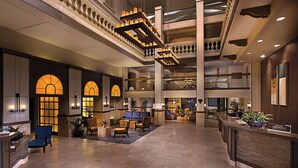 A spacious lobby with a high ceiling, multiple seating areas, and a reception desk. - Water Oasis + Golf Course + Spa! 1 Bedroom Suite. (Phoenix)
