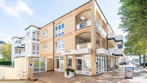 A multi-story building with a ground-level gallery and upper-level balconies.