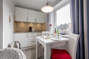 Fridge, stovetop, dishwasher, coffee/tea maker