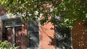 A brick building with a double door and a window with shutters. - Trendy West Town Flat - 2 bed / 1.5 bath with parking (Chicago)