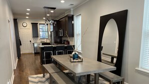 A modern kitchen with dark cabinets, stainless steel appliances, and a central island. - Trendy West Town Flat - 2 bed / 1.5 bath with parking (Chicago)