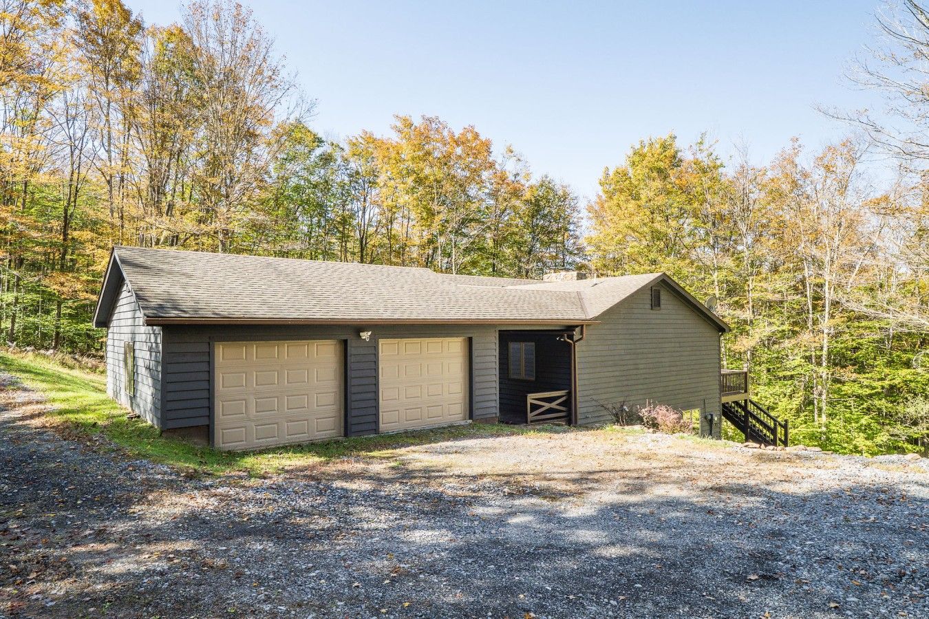 A single-story building with a garage and a small porch.