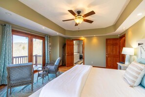 A bedroom with a bed, a ceiling fan, a window, and a door. - A Tree Top Mountain Home - Views, Game Room, Pet Friendly (Banner Elk)