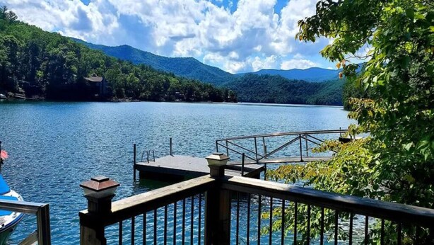 A lake with a wooden dock and a boat. - House On Blue Waters is a very special lake front property with amazing views (Lake Santeetlah)