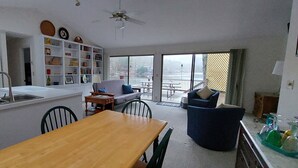 A compact living space with a kitchen, dining area, and a balcony with a view. - House On Blue Waters is a very special lake front property with amazing views (Lake Santeetlah)