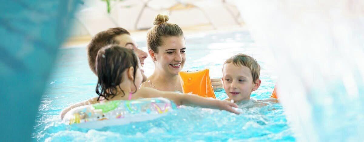 A swimming pool with people in it.