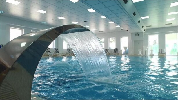 An indoor swimming pool with a water feature. - Caprioara Spa&Wellness Resort (Covasna)