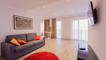 Apartment, 1 Queen Bed | Living room | 30-inch TV with cable channels