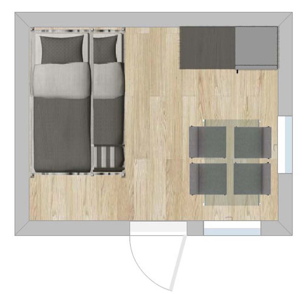 A room with a bed, a small table, and a seating area.