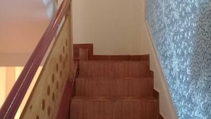 A staircase with wooden steps and a wooden handrail with circular cutouts. - Hoa Hong Do Guesthouse (Xuan Huong - Da Lat)