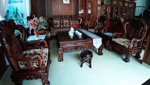 A traditional wooden furniture set with a sofa, chairs, and a coffee table. - Kings 2 Hotel (Thong Nhat)