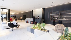 A modern lobby with seating areas, a reception desk, and a J-Base sign. - Hotel JAL City Toyama (Toyama)